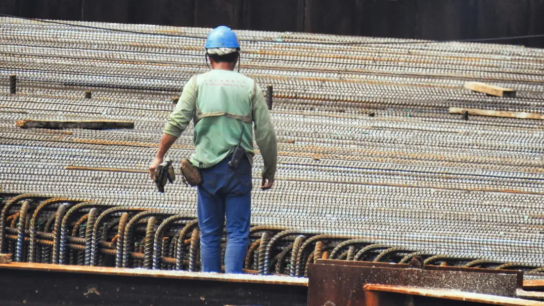 Supervisión técnica y seguridad en obra — constructora CDMX Supervisor de obra observando armado de acero
